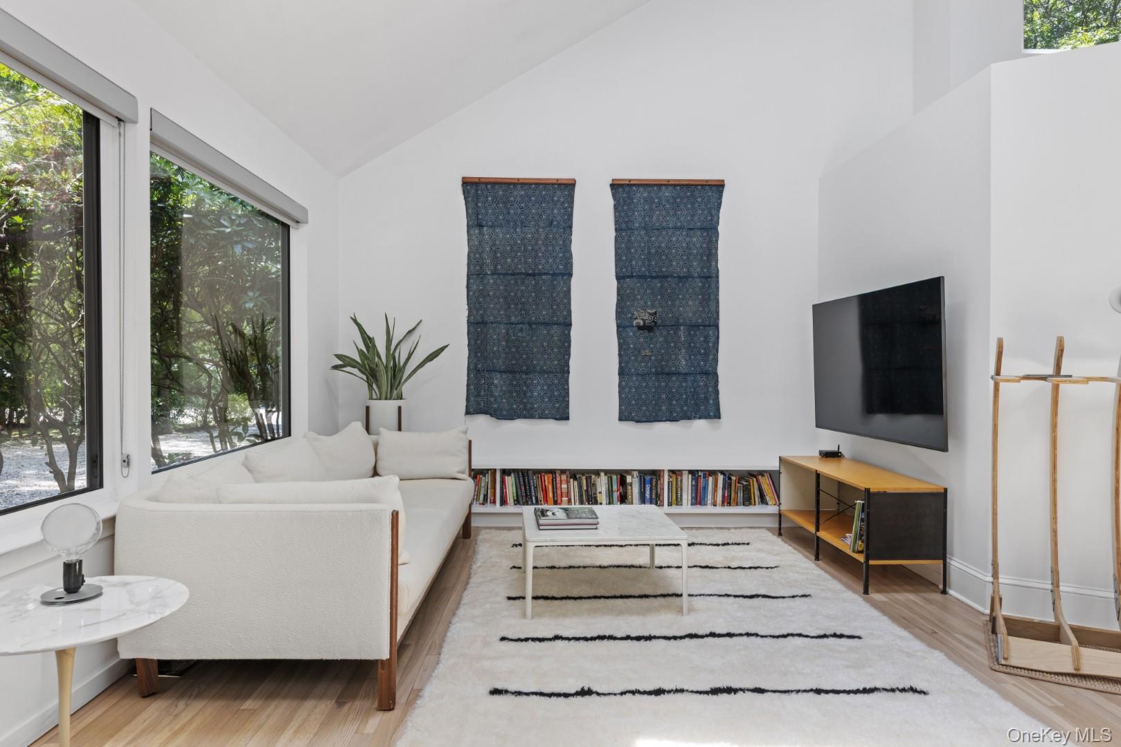 24 Quogue Riverhead Road Quogue, NY 11959 - Photo 6 of 22 a spacious bedroom with a large bed and a flat screen tv