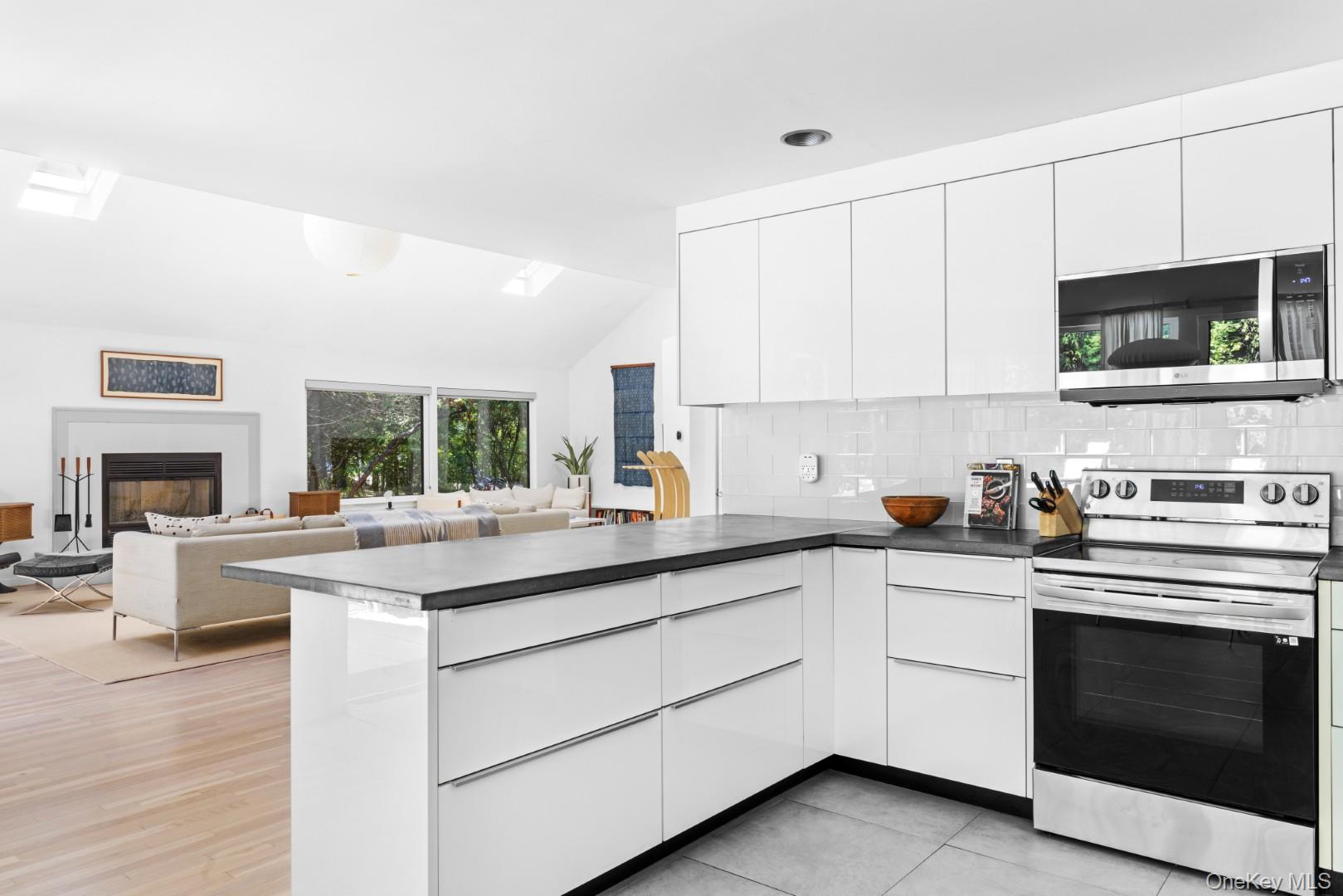 24 Quogue Riverhead Road Quogue, NY 11959 - Photo 9 of 22 a kitchen with a stove sink and microwave