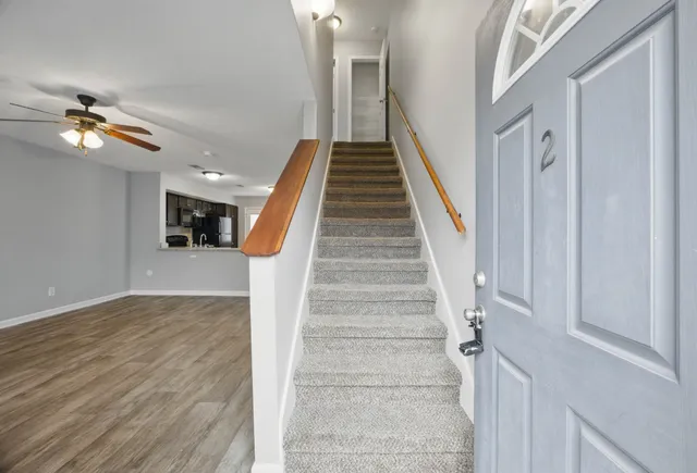a view of entryway and hall with wooden floor