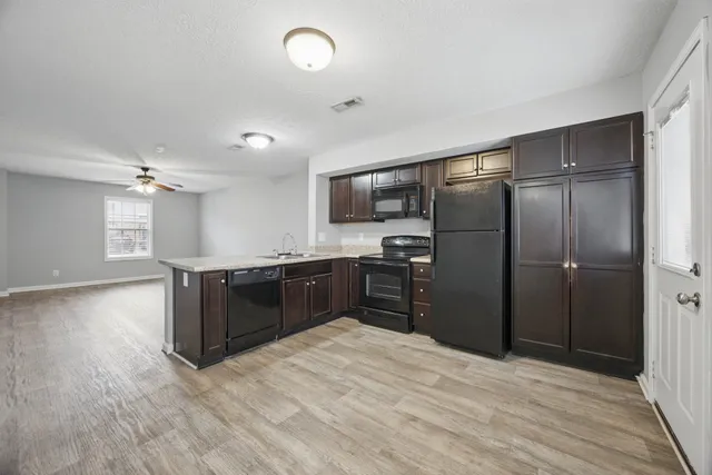 a kitchen with a refrigerator and a sink