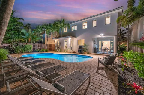 a view of a house with swimming pool and yard