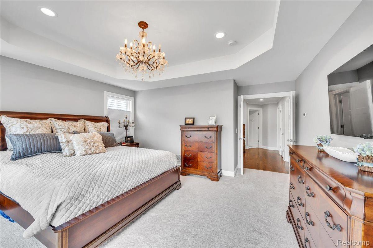 142 Griggs Street Rochester, MI 48307 - Photo 24 of 51 Spacious room featuring a decorative chandelier, recessed lighting, and a tray ceiling