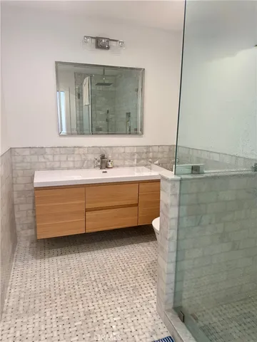 a bathroom with a sink a mirror and a bathtub