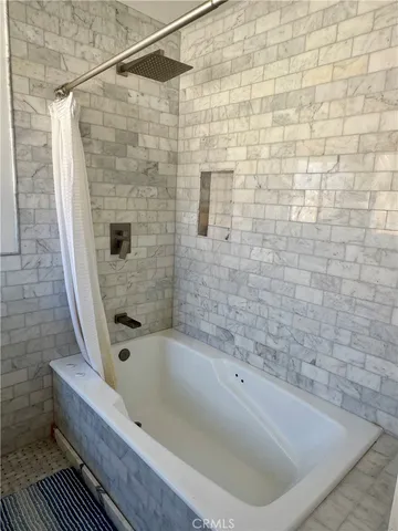 a bathroom with a bathtub and shower