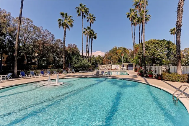 a view of a swimming pool with a patio and a yard