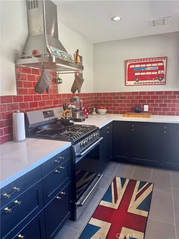 a kitchen with stainless steel appliances granite countertop a stove and a sink