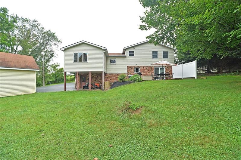 1210 West Lancaster Road Harmony, PA 16037 - Photo 22 of 24 This view shows the MAN DOOR from the 2 car garage w/ a concrete under roof storage/seating area as well. 20'x20' outbuilding also features a covered, under-building storage area perfect for equipment storage.