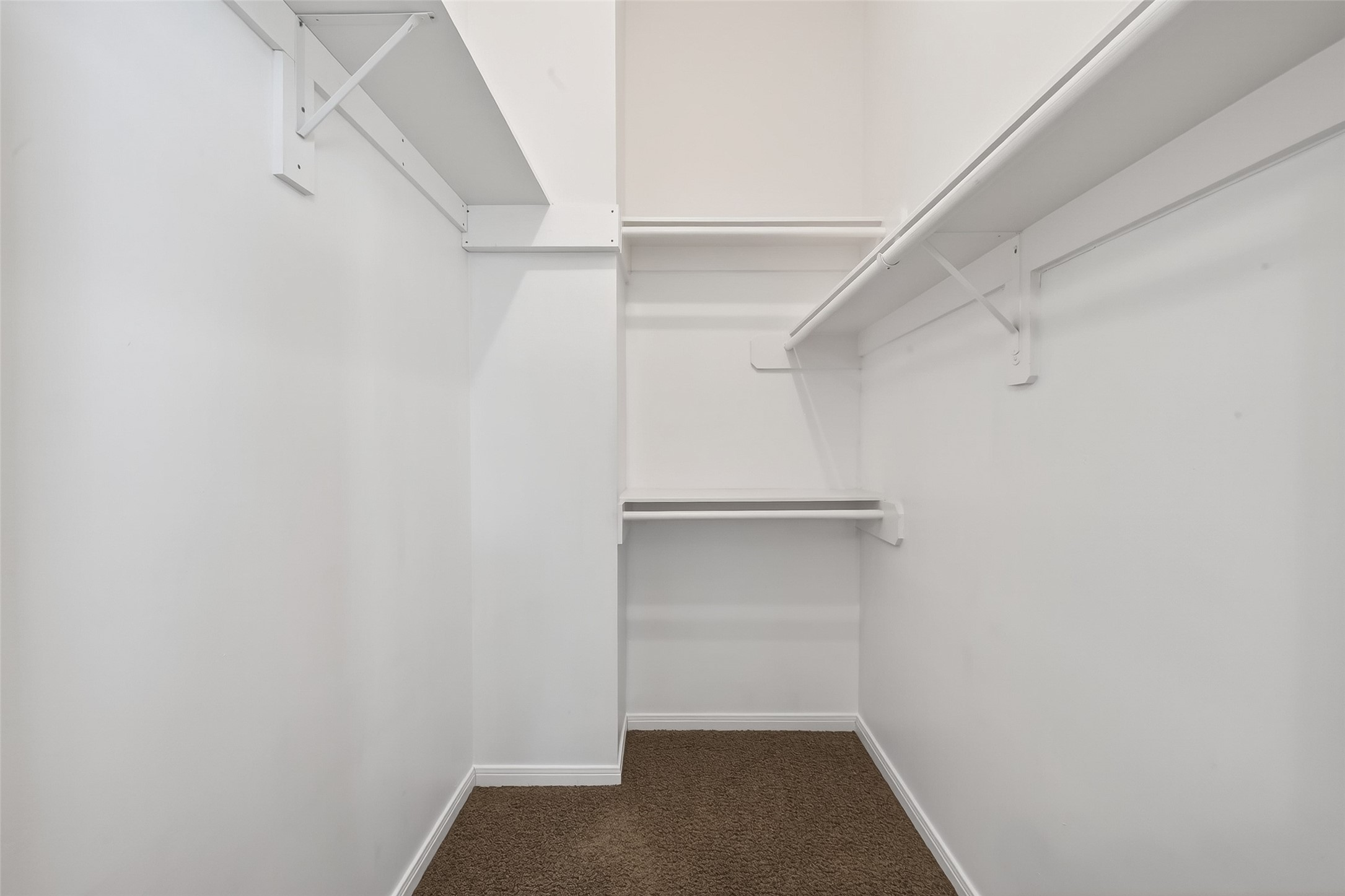 2804 Chenevert Street Houston, TX 77004 - Photo 32 of 37 a view of walk in closet with empty racks