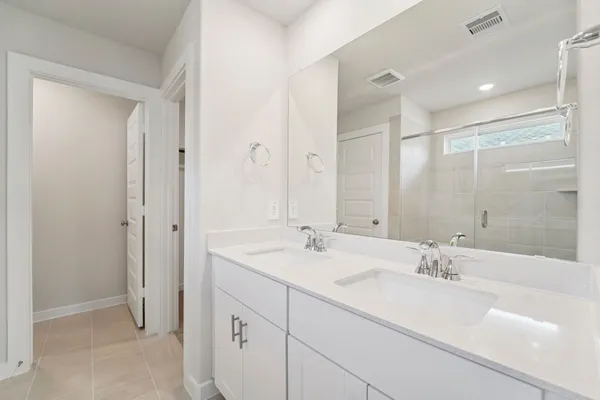 a bathroom with a shower sink and mirror