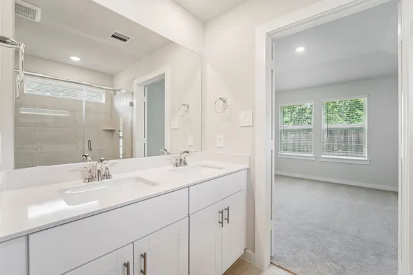 a bathroom with a shower and a sink