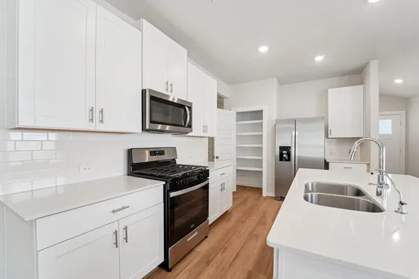 a kitchen with a sink a stove and refrigerator