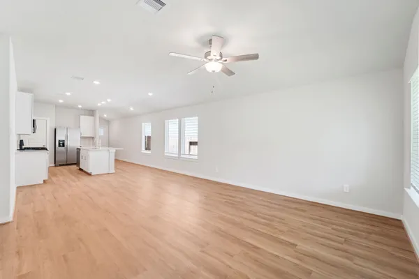 a view of an empty room with a kitchen