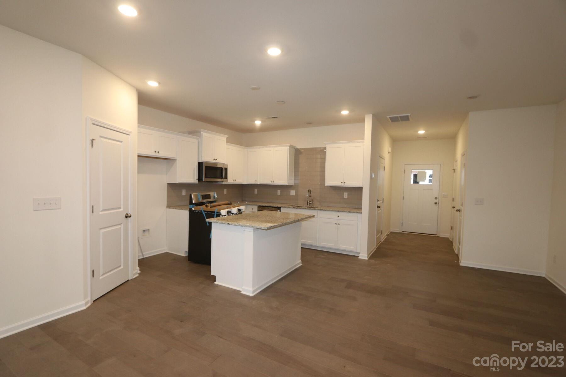 345 Willowsford Drive Monroe, NC 28110 - Photo 3 of 9 a kitchen with a refrigerator and white cabinets