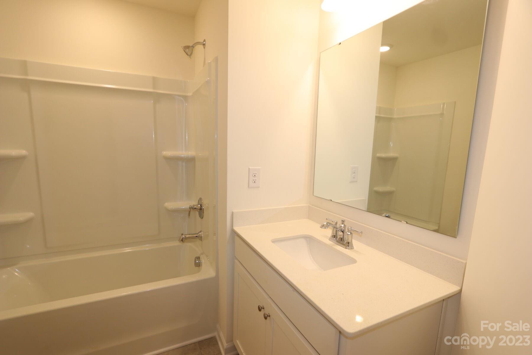 345 Willowsford Drive Monroe, NC 28110 - Photo 7 of 9 a bathroom with a granite countertop sink a shower and a mirror