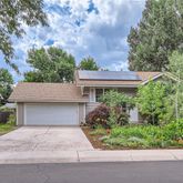 front view of house with a yard and potted plants