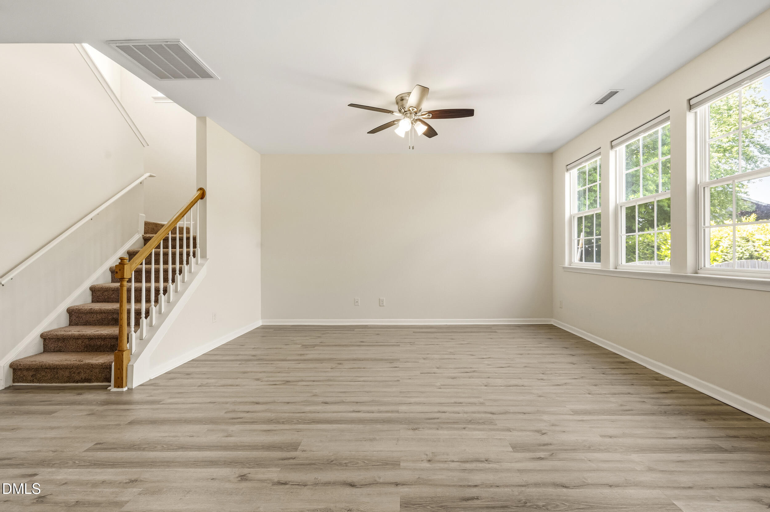 112 Ryder Cup Circle Raleigh, NC 27603 - Photo 12 of 45 a view of an empty room with wooden floor and a window