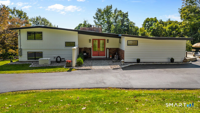 a view of a house with swimming pool and a yard