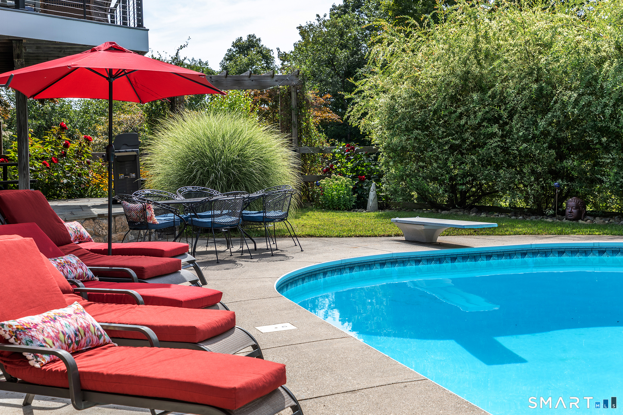 145 Pine Hill Road New Fairfield, CT 06812 - Photo 30 of 35 a view of a swimming pool with a table and chairs under an umbrella