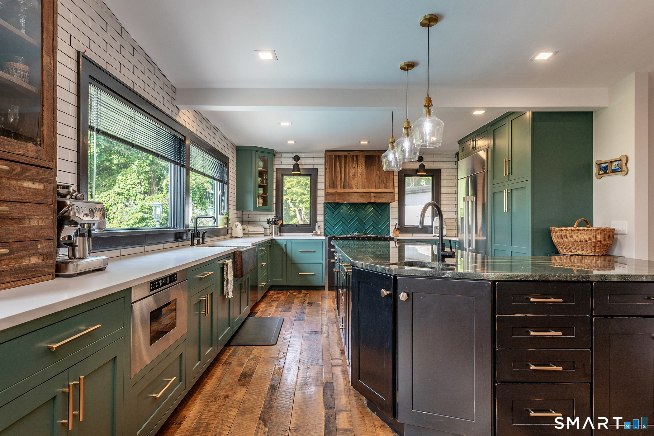 145 Pine Hill Road New Fairfield, CT 06812 - Photo 7 of 35 a kitchen with stainless steel appliances granite countertop a sink a stove and a wooden floors