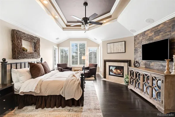 a spacious bedroom with a bed and a flat screen tv