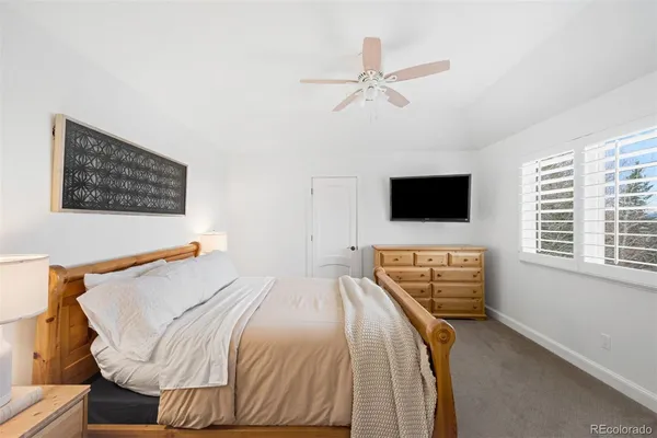 a spacious bedroom with a bed and a couch