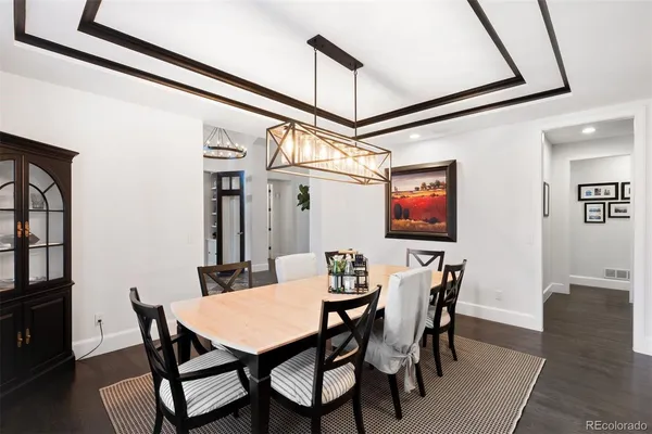 a kitchen with a sink and a wooden floor