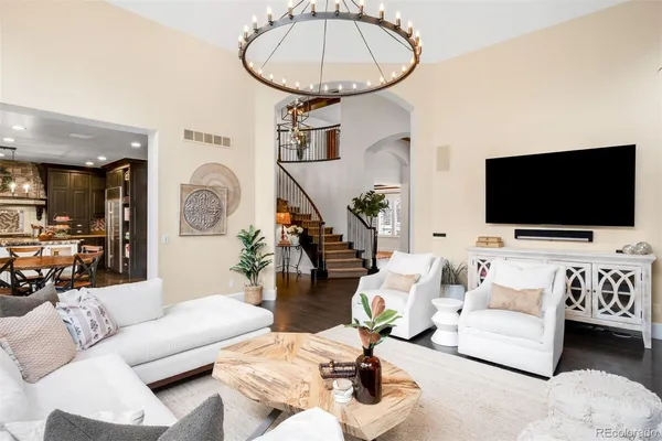 a kitchen with stainless steel appliances kitchen island granite countertop a dining table chairs and refrigerator