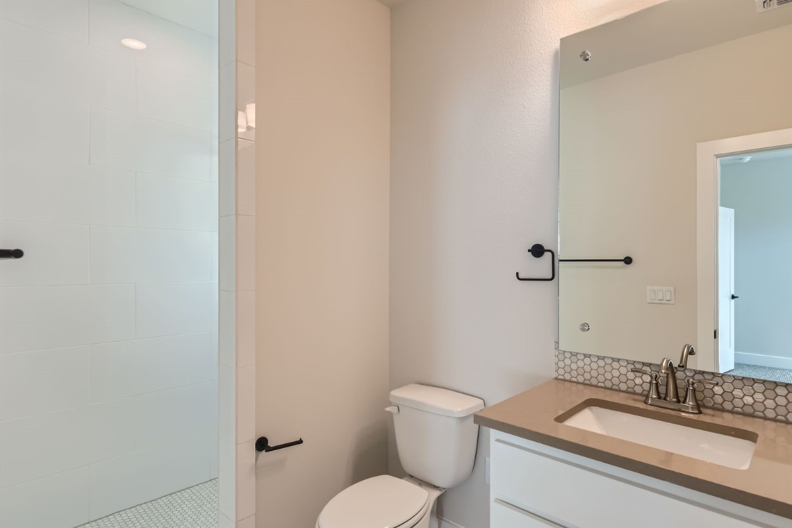 9101 Cattle Baron Path Austin, TX 78747 - Photo 11 of 29 a bathroom with a granite countertop toilet sink and mirror