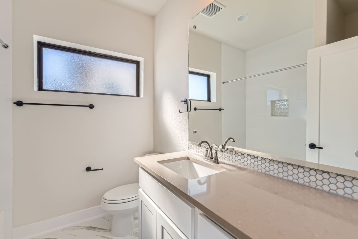 9101 Cattle Baron Path Austin, TX 78747 - Photo 15 of 29 a bathroom with a sink a toilet and mirror
