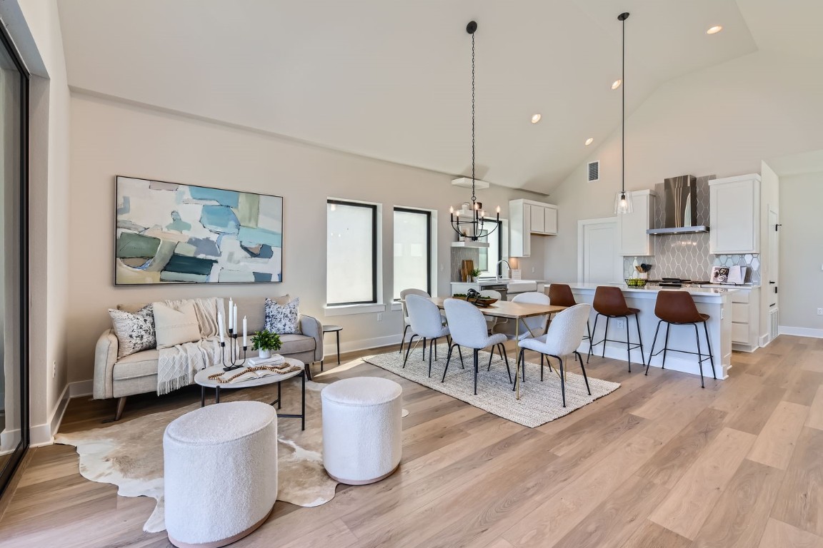 9101 Cattle Baron Path Austin, TX 78747 - Photo 16 of 29 a living room with furniture a rug and a chandelier