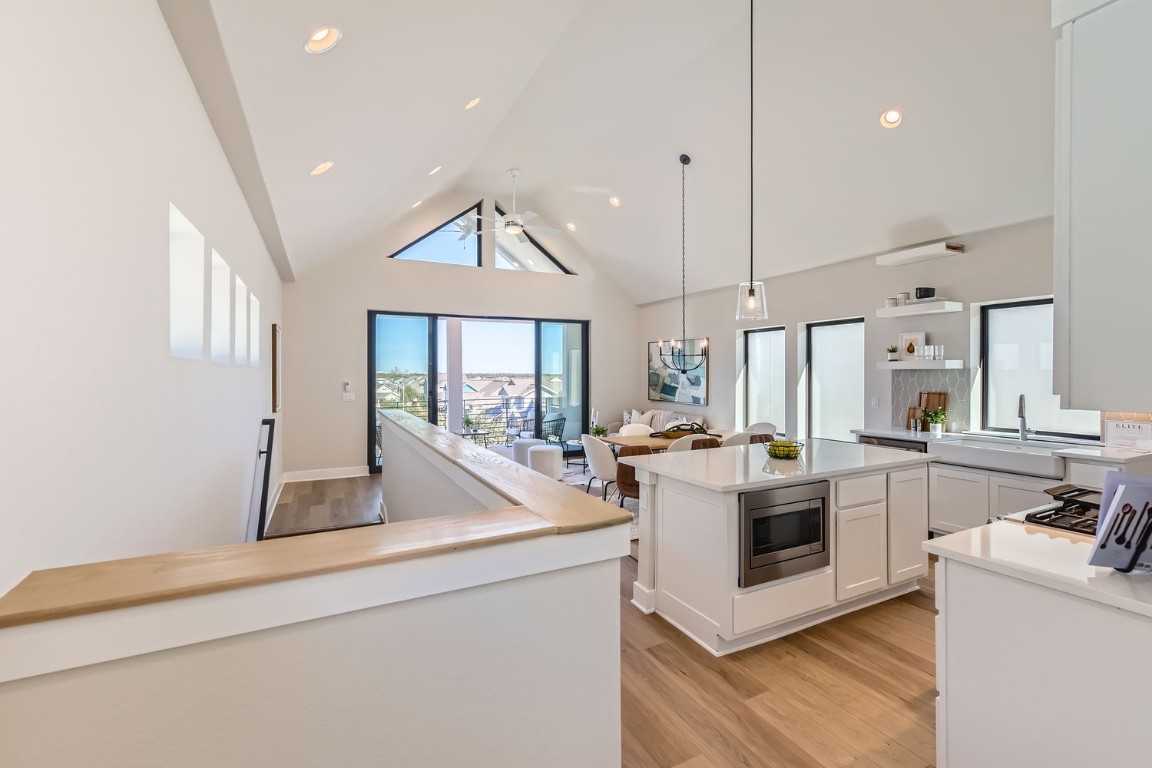 9101 Cattle Baron Path Austin, TX 78747 - Photo 18 of 29 a open kitchen with stainless steel appliances granite countertop a sink stove and white cabinets with wooden floor