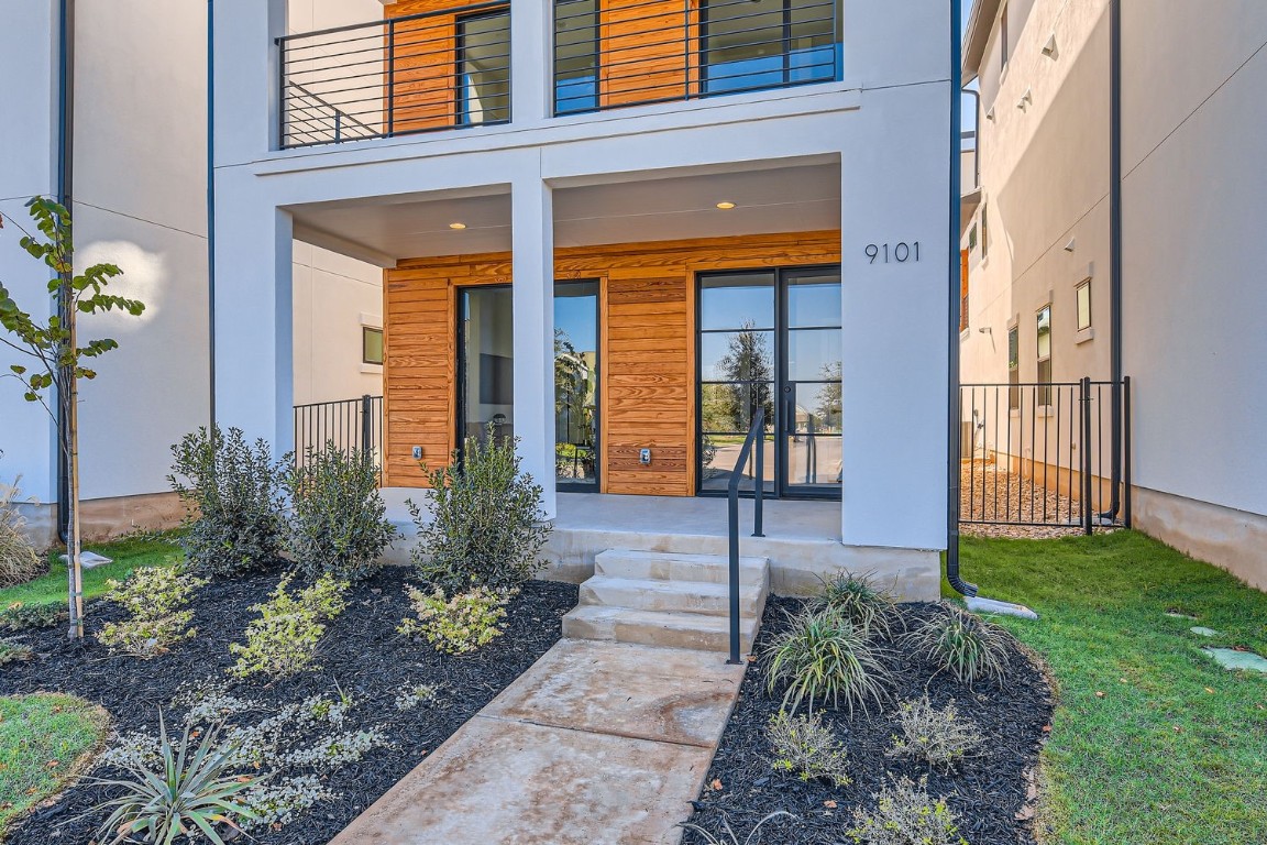 9101 Cattle Baron Path Austin, TX 78747 - Photo 3 of 29 a front view of a house with garden