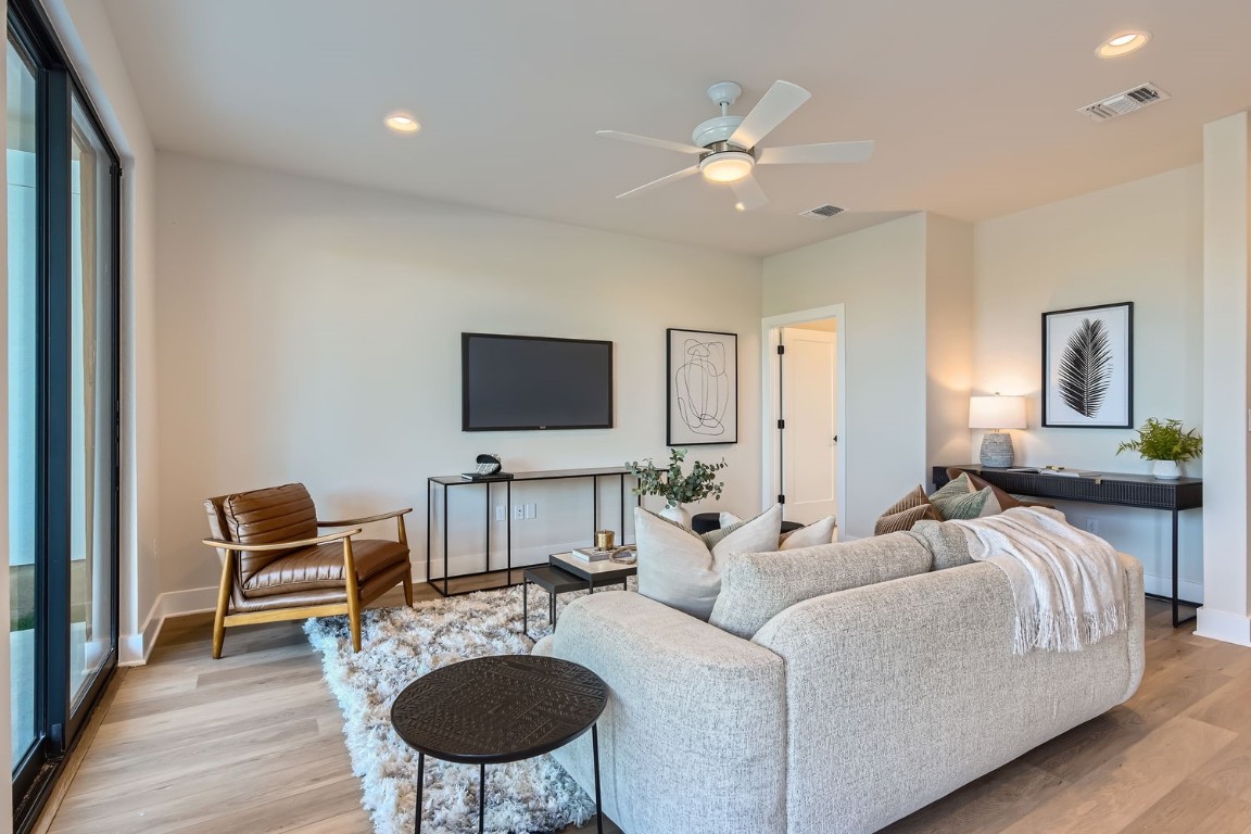 9101 Cattle Baron Path Austin, TX 78747 - Photo 4 of 29 a living room with furniture a flat screen tv and kitchen view
