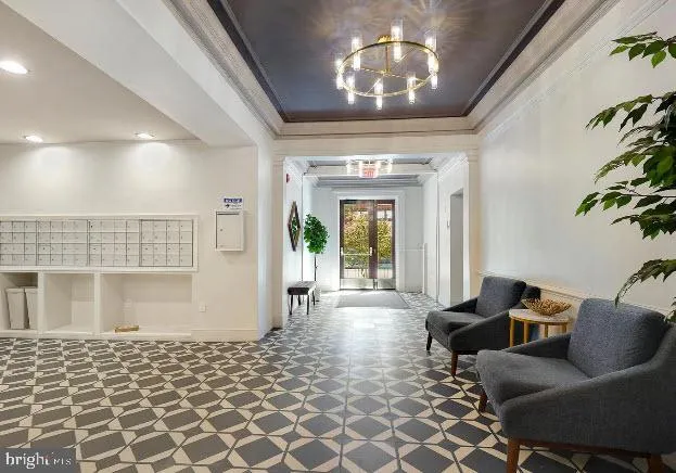 a living room with furniture and a chandelier