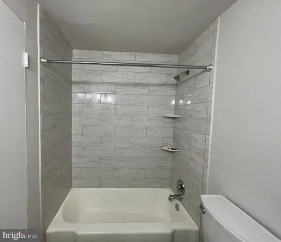 a bathroom with a shower and a bath tub