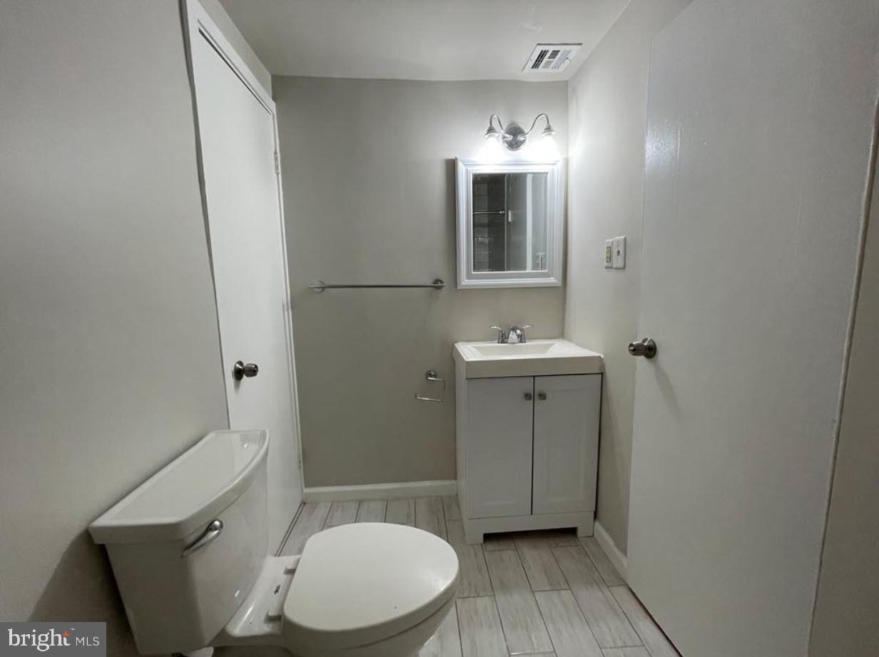 1669 Columbia Road Northwest, Unit 215 Washington, DC 20009 - Photo 23 of 25 a bathroom with a toilet sink and mirror