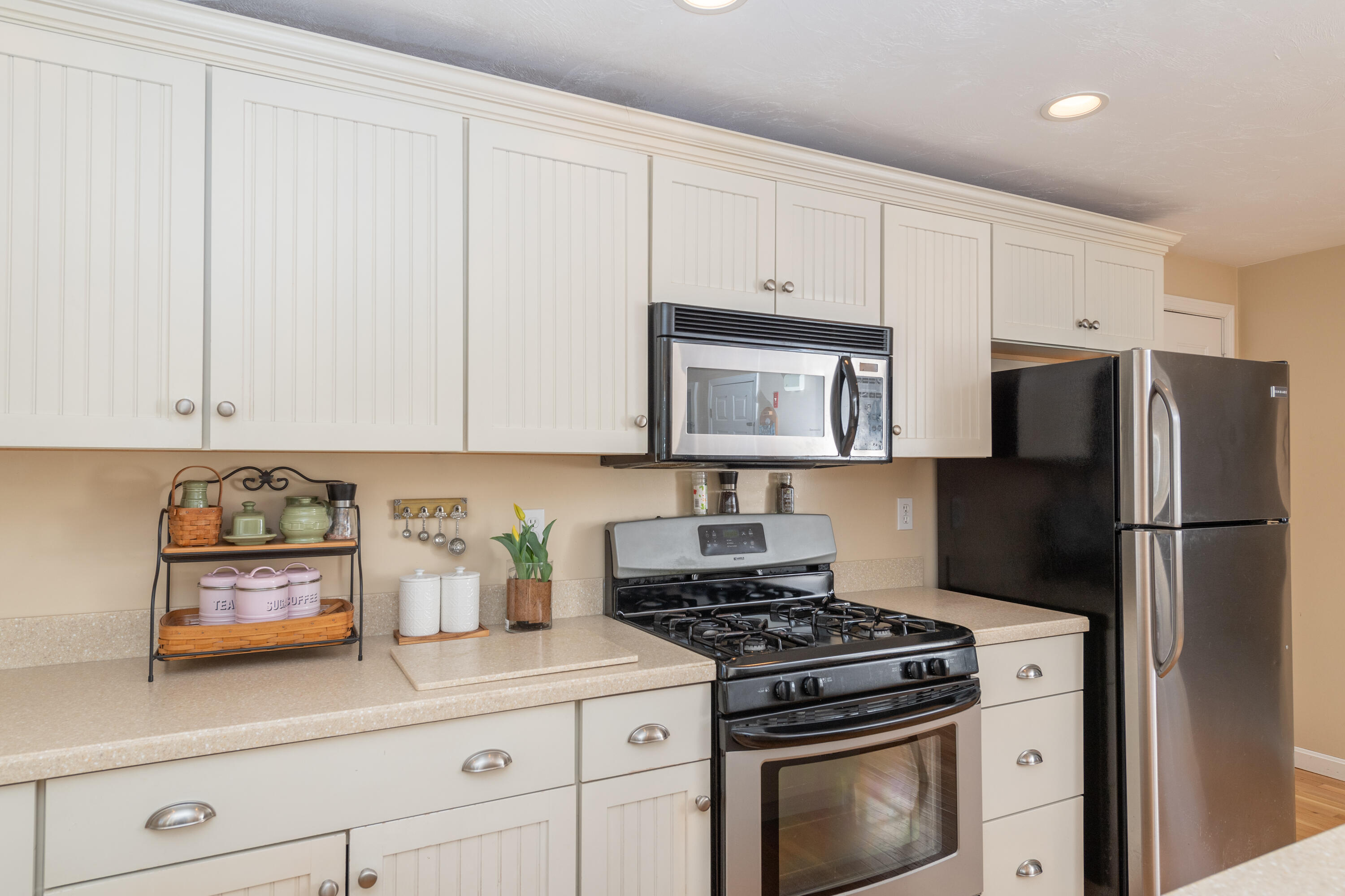19 Carleton Drive Mashpee, MA 02649 - Photo 17 of 45 a kitchen with stainless steel appliances white cabinets and a stove a refrigerator a sink