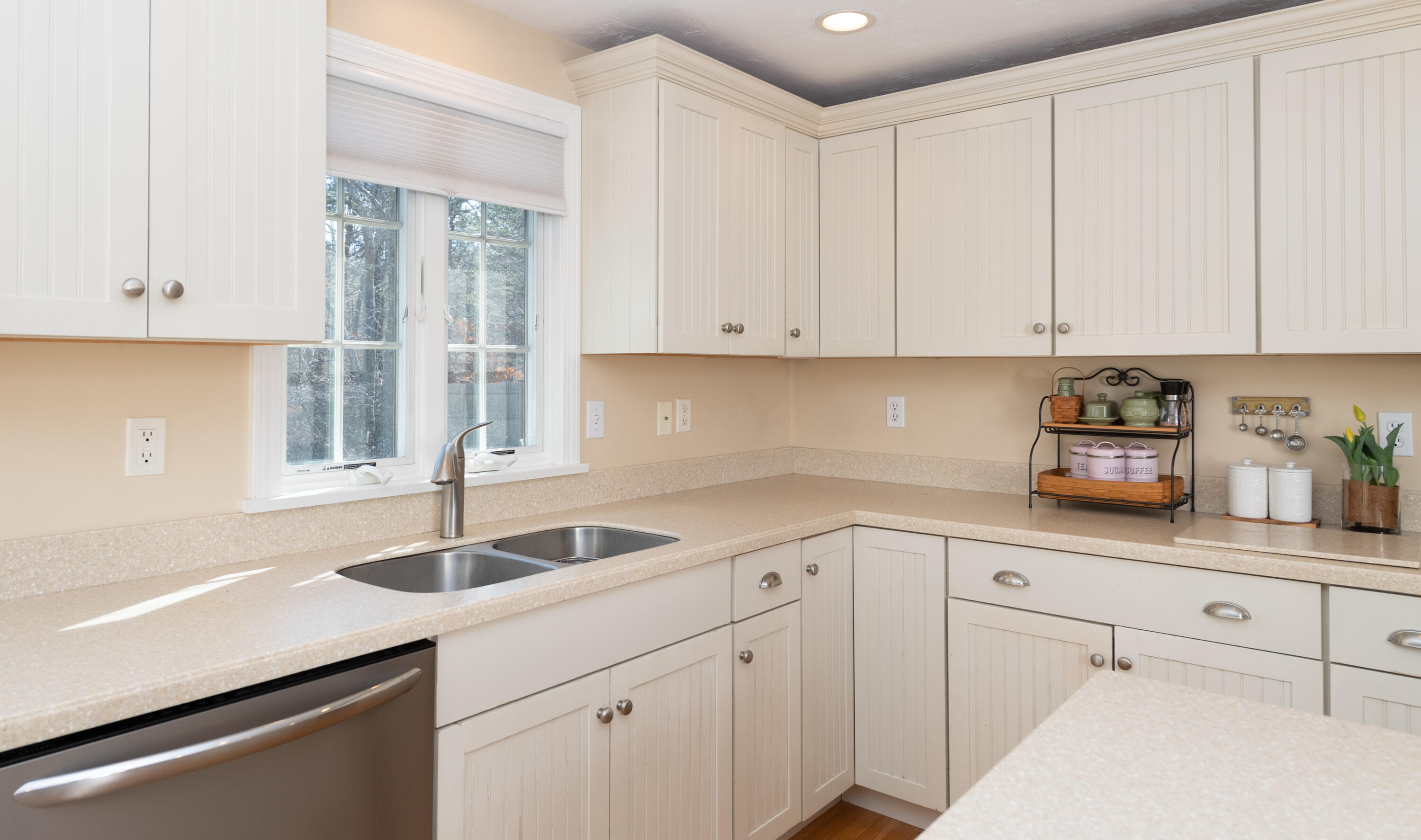 19 Carleton Drive Mashpee, MA 02649 - Photo 18 of 45 a kitchen with white cabinets and sink