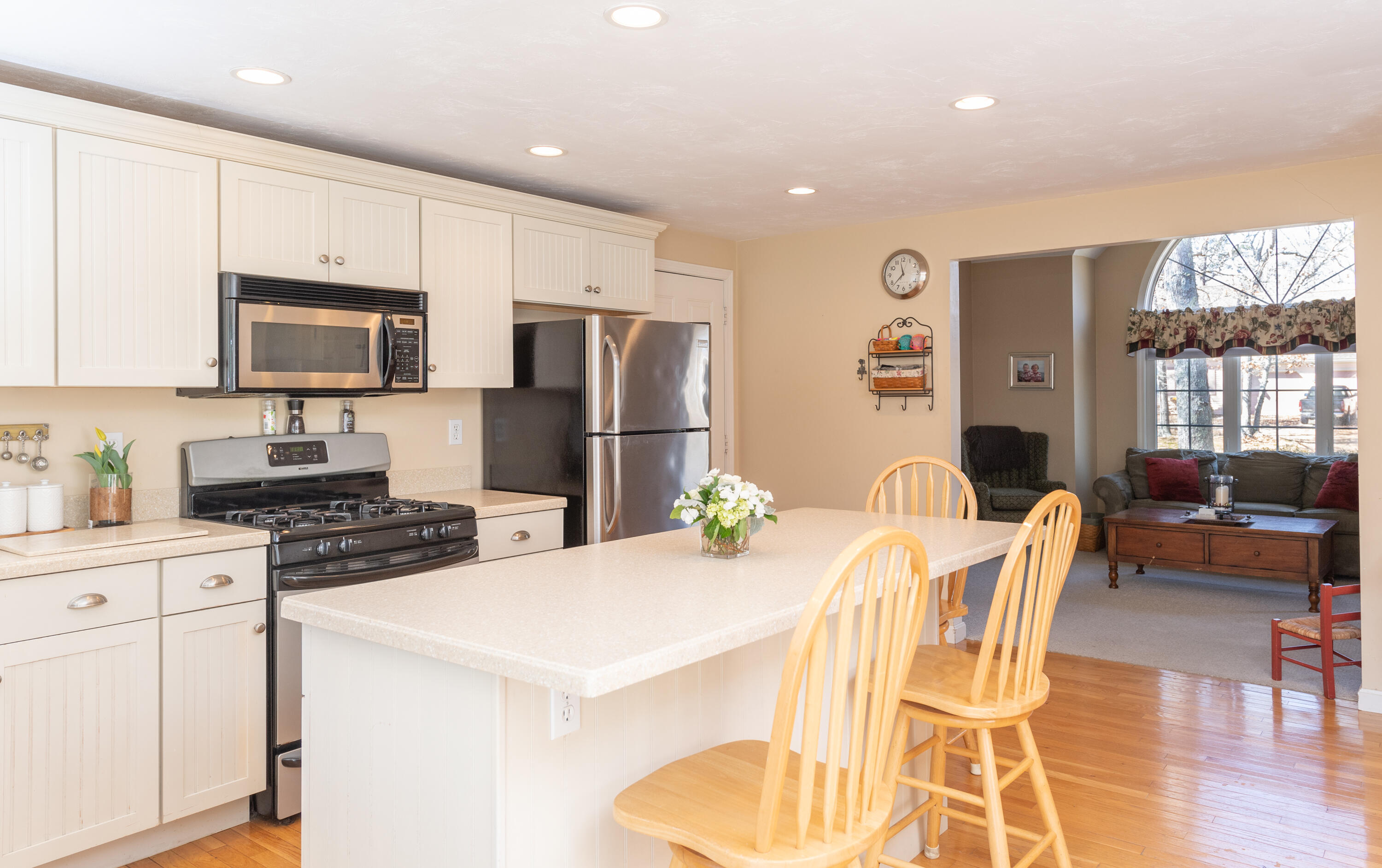 19 Carleton Drive Mashpee, MA 02649 - Photo 19 of 45 a kitchen with stainless steel appliances a refrigerator a stove a dining table and chairs