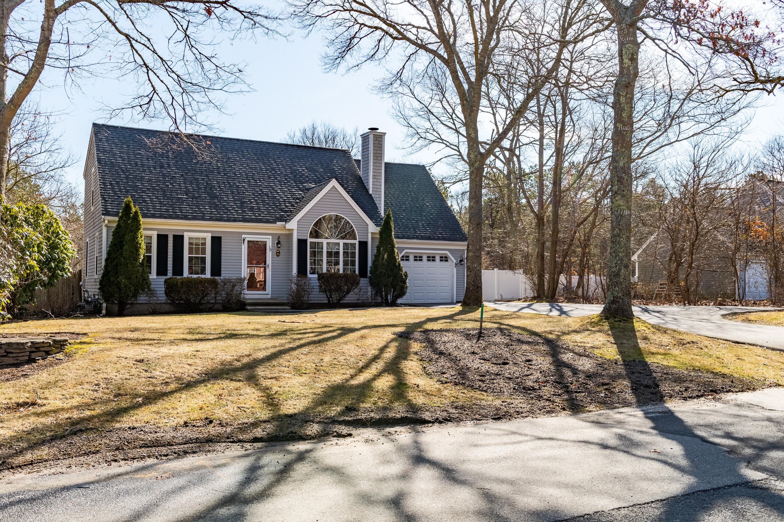 19 Carleton Drive Mashpee, MA 02649 - Photo 2 of 45 a front view of a house with a yard