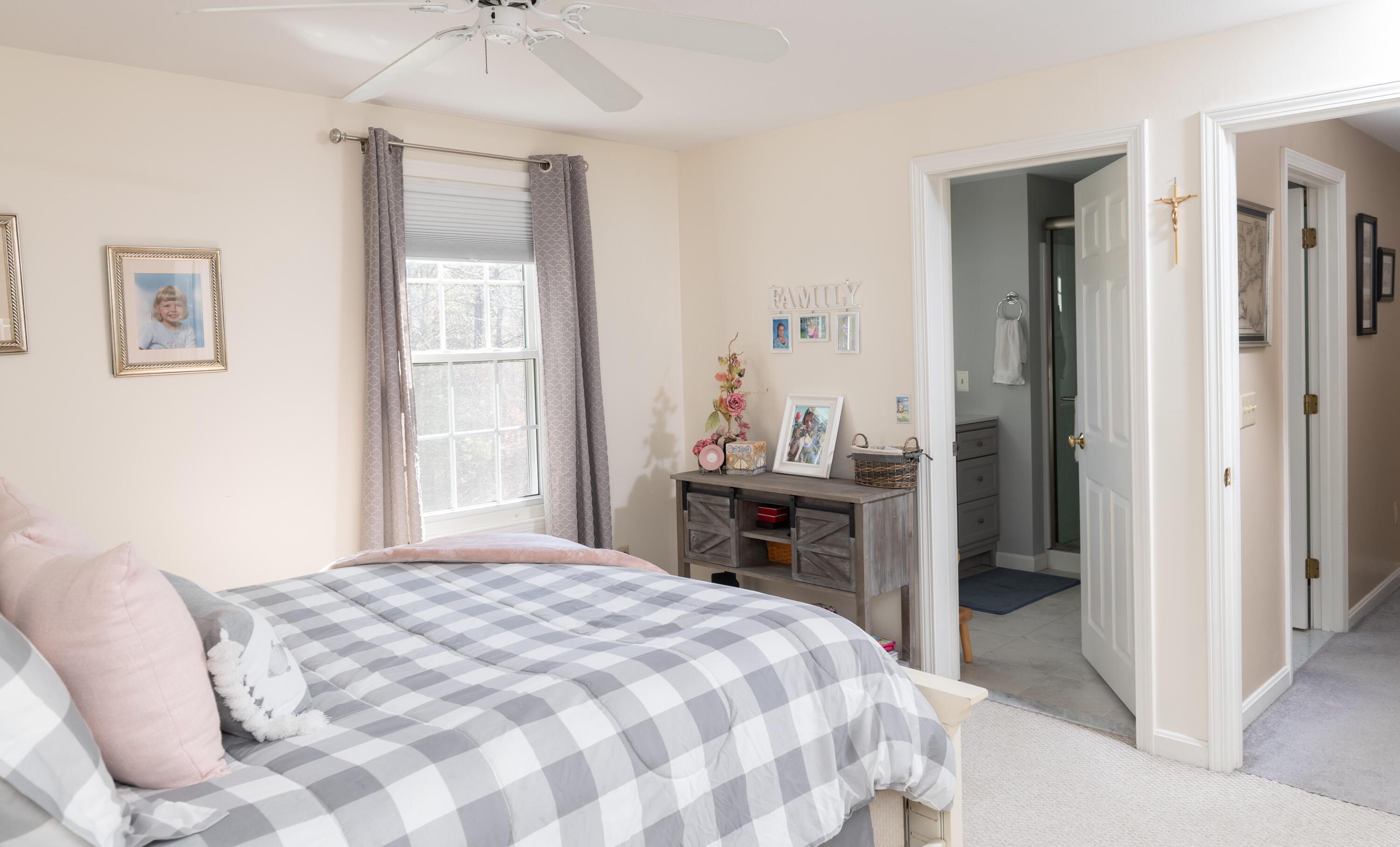 19 Carleton Drive Mashpee, MA 02649 - Photo 29 of 45 a bedroom with a bed and a chandelier