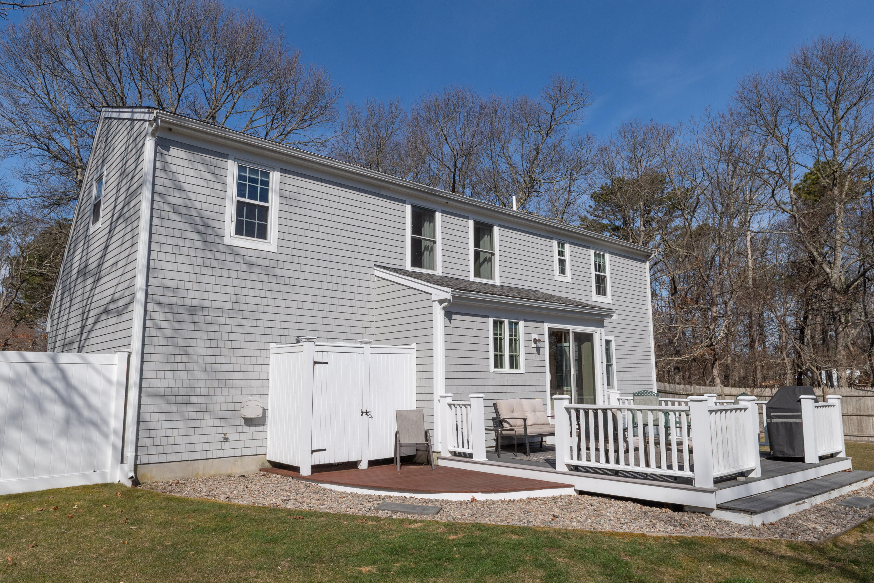 19 Carleton Drive Mashpee, MA 02649 - Photo 34 of 45 a view of a house with a yard and wooden fence