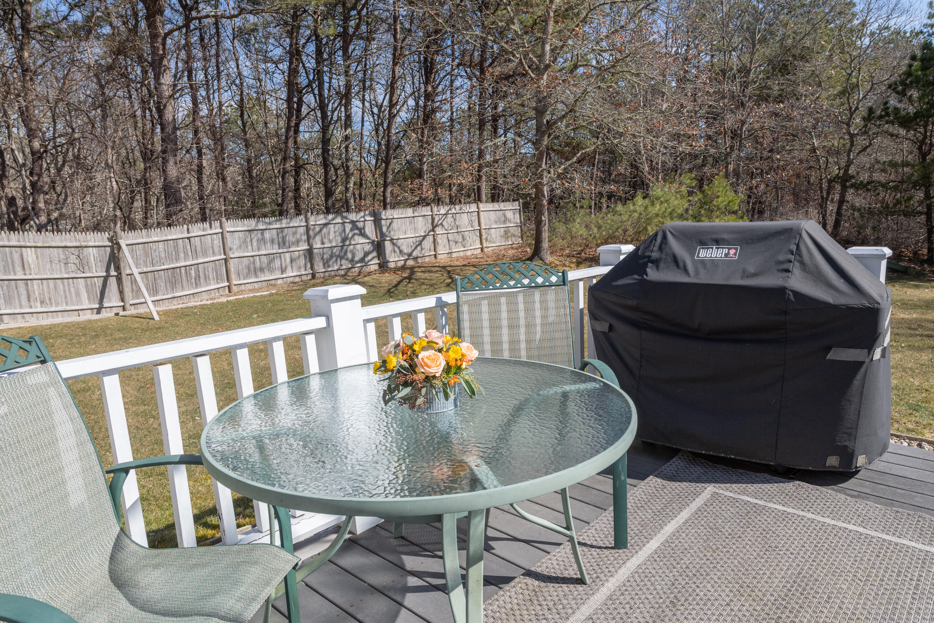 19 Carleton Drive Mashpee, MA 02649 - Photo 38 of 45 a deck of a house with table and chairs