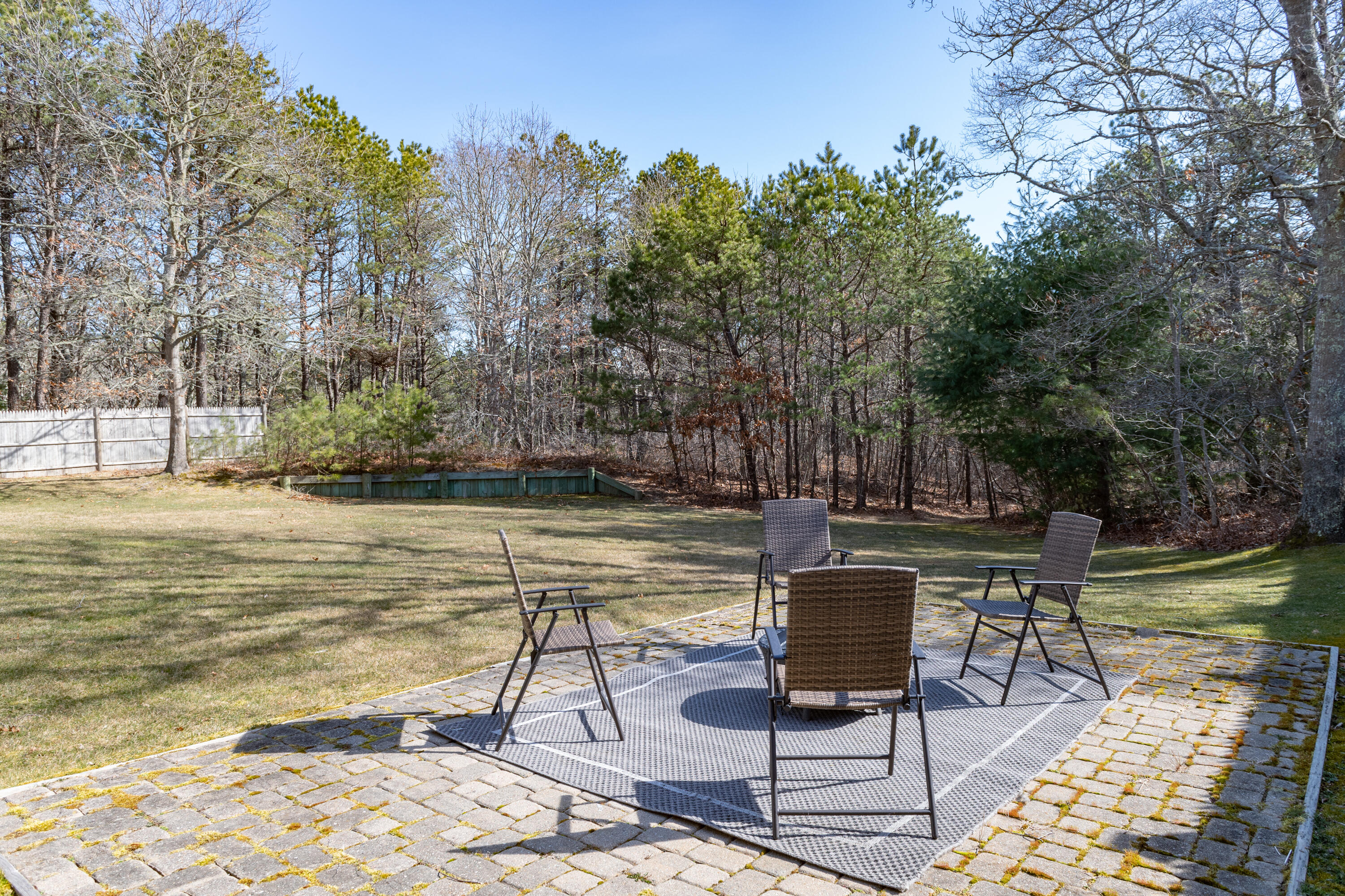 19 Carleton Drive Mashpee, MA 02649 - Photo 39 of 45 a view of a lake with table and chairs