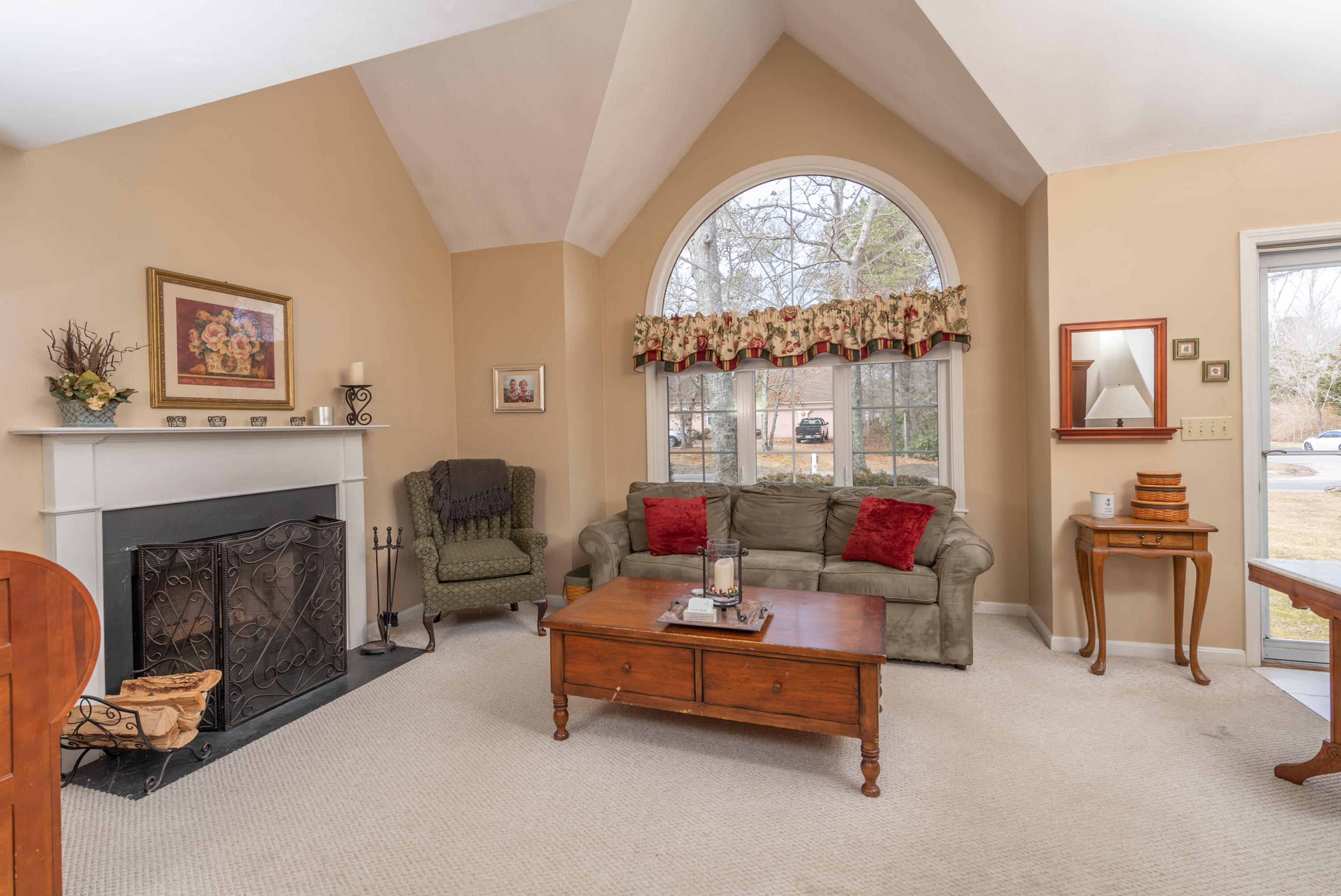 19 Carleton Drive Mashpee, MA 02649 - Photo 10 of 45 a living room with furniture a fireplace and a large window