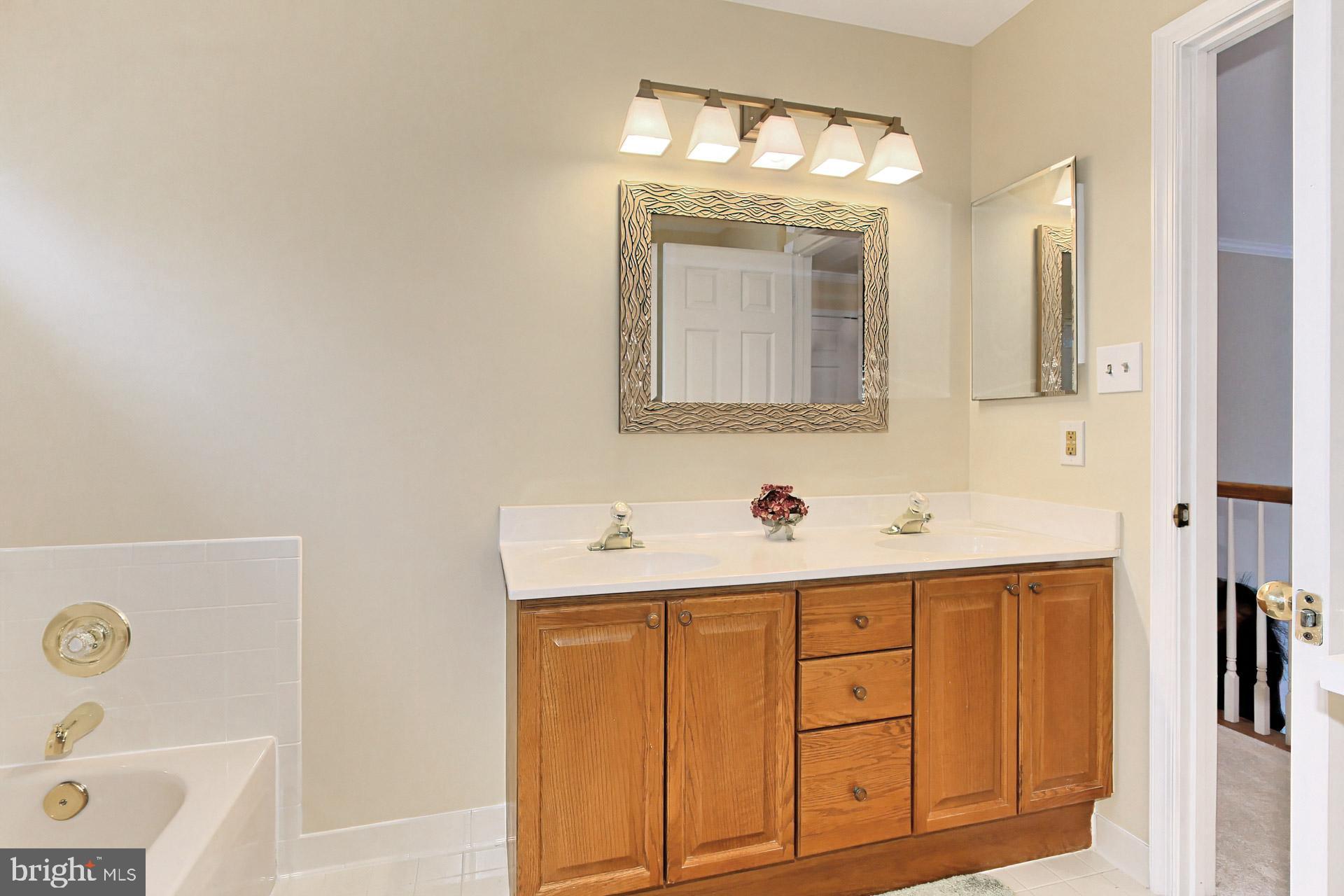 8126 Ridge Creek Way Springfield, VA 22153 - Photo 29 of 50 a bathroom with a sink and a mirror