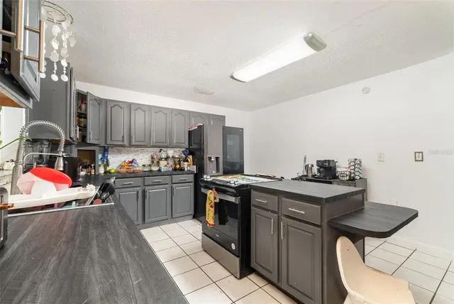 a kitchen with a stove sink and cabinets