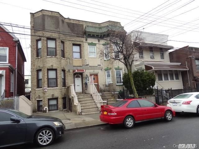 33-16 97th Street Queens, NY 11368 - Photo 1 of 1 a car parked in front of a house