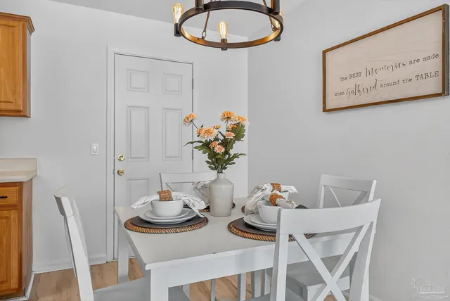 a view of a dining room with furniture and a potted plant