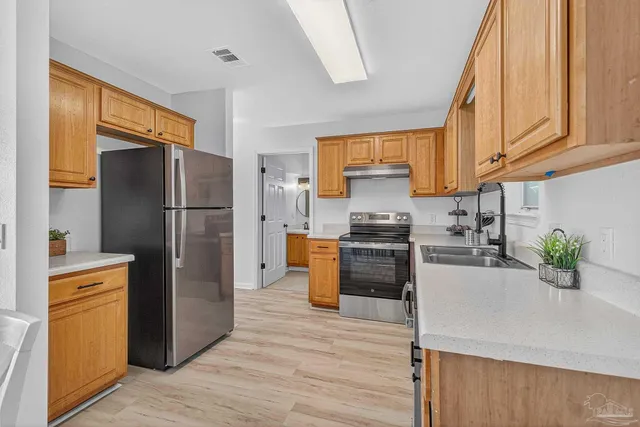 a kitchen with a refrigerator and a sink